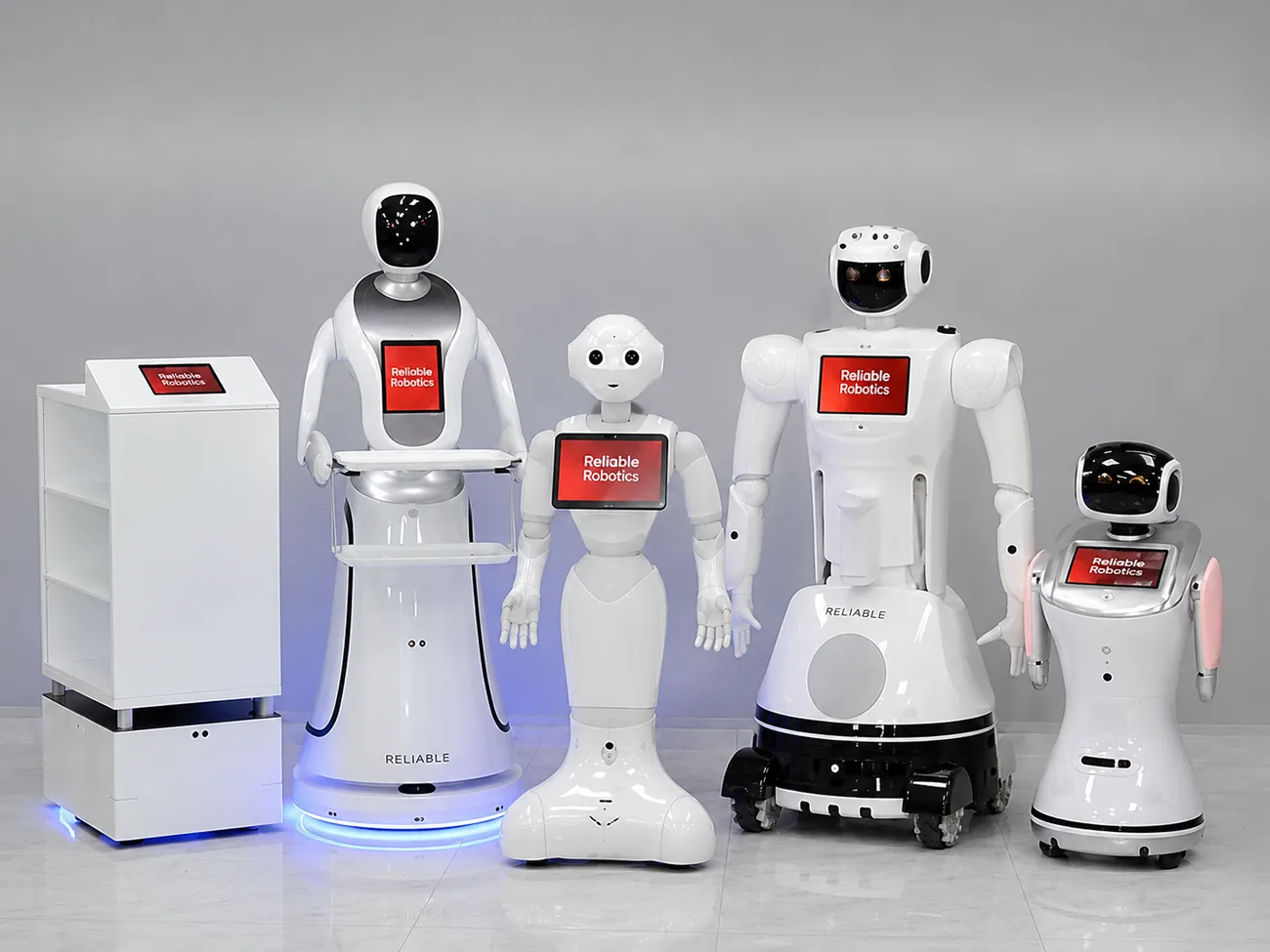 A lineup of service and humanoid robots branded Reliable Robotics, set up for a live activation